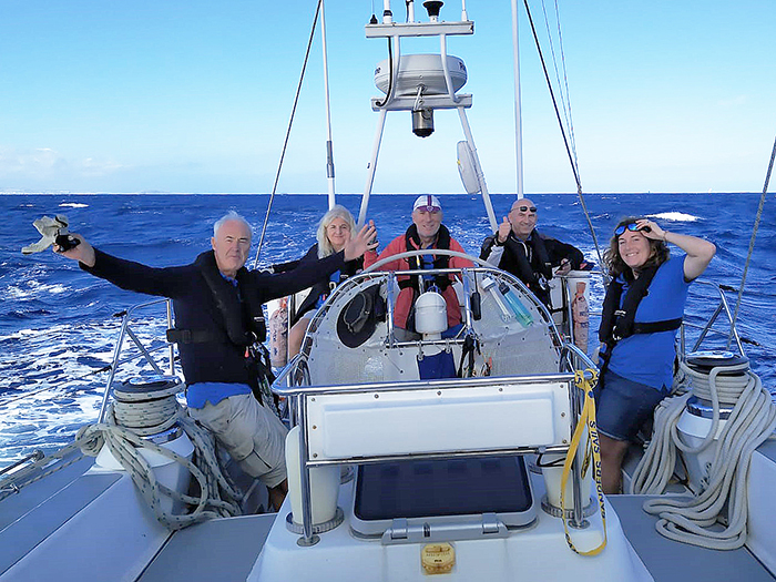 Crew enjoying downwind trade-wind sailing across the Atlantic Ocean