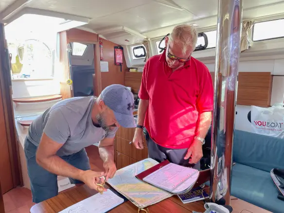 RYA instructor briefing crew on passage planning exercise at Shamrock Quay