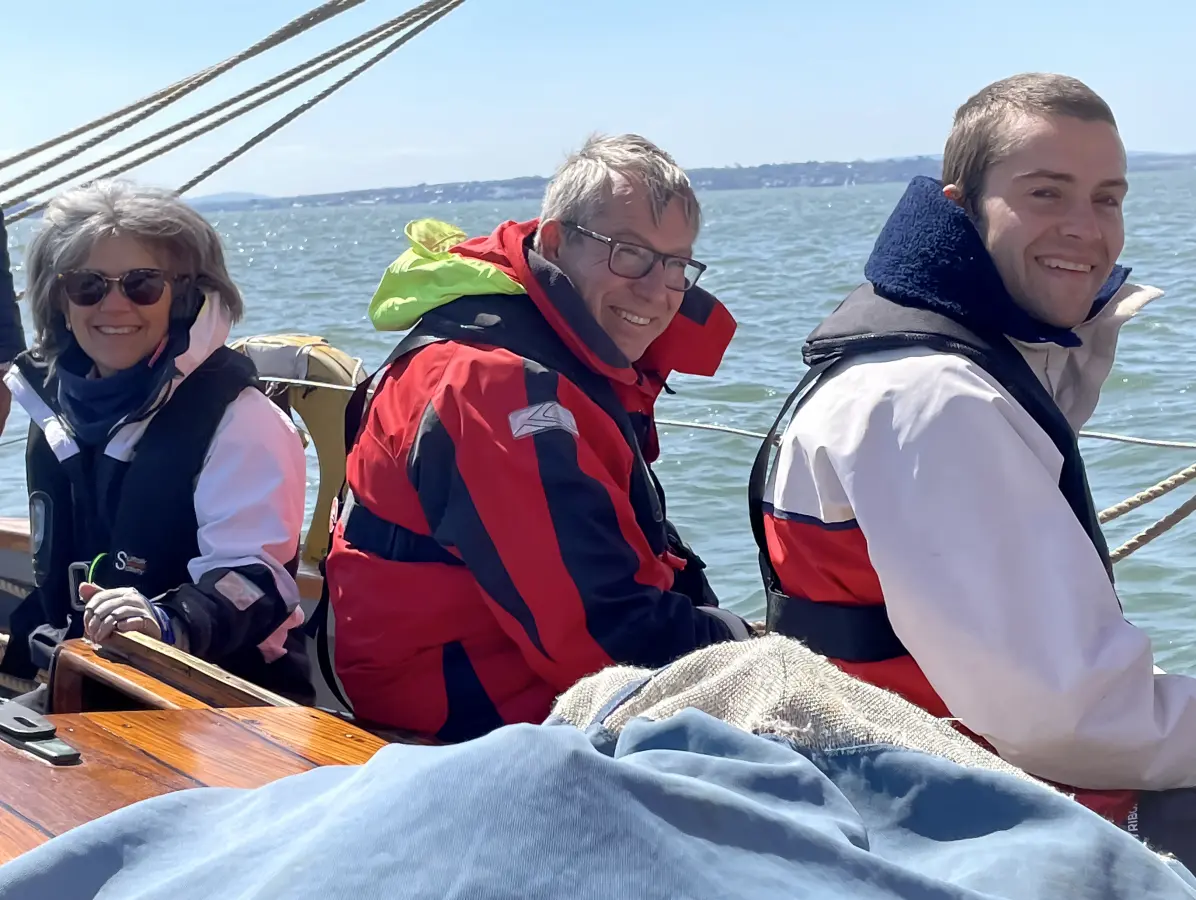 Students learning sail handling in autumn conditions on an RYA sailing course