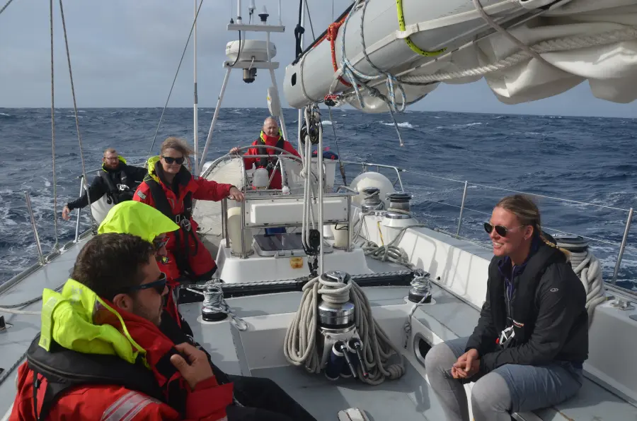 Crew helming yacht on return passage from Antigua to Portsmouth