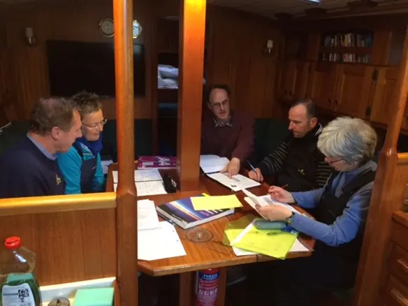 RYA Coastal Skipper instructor briefing crew on night sailing plan